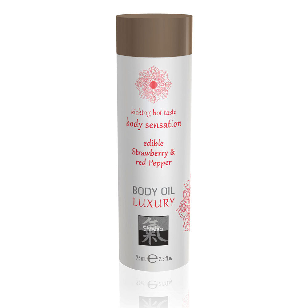 Shiatsu strawberry and red pepper body oil, a red tinted edible massage oil in a bottle.