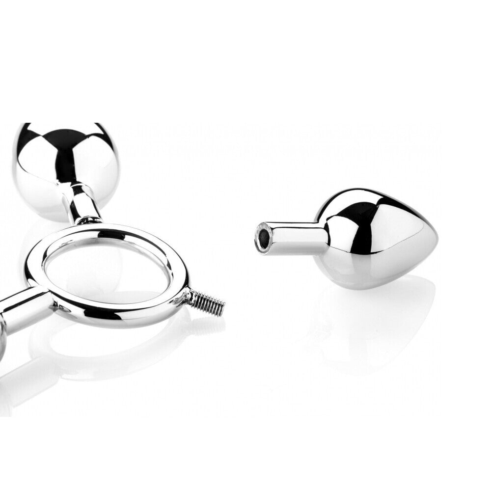 A set of three metal butt plugs from The Red, shaped like pig toys