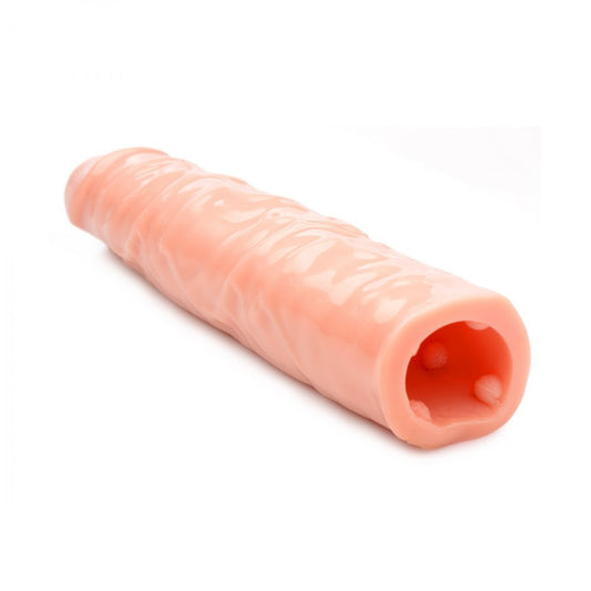 Flesh-coloured penis sleeve extender, three inches, for enhancement, made of flexible material.