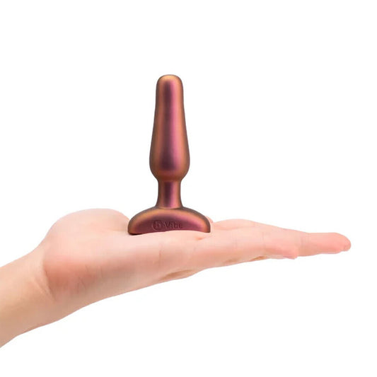 B-Vibe novice limited edition vibrating buttplug, smooth purple silicone with a contoured design.