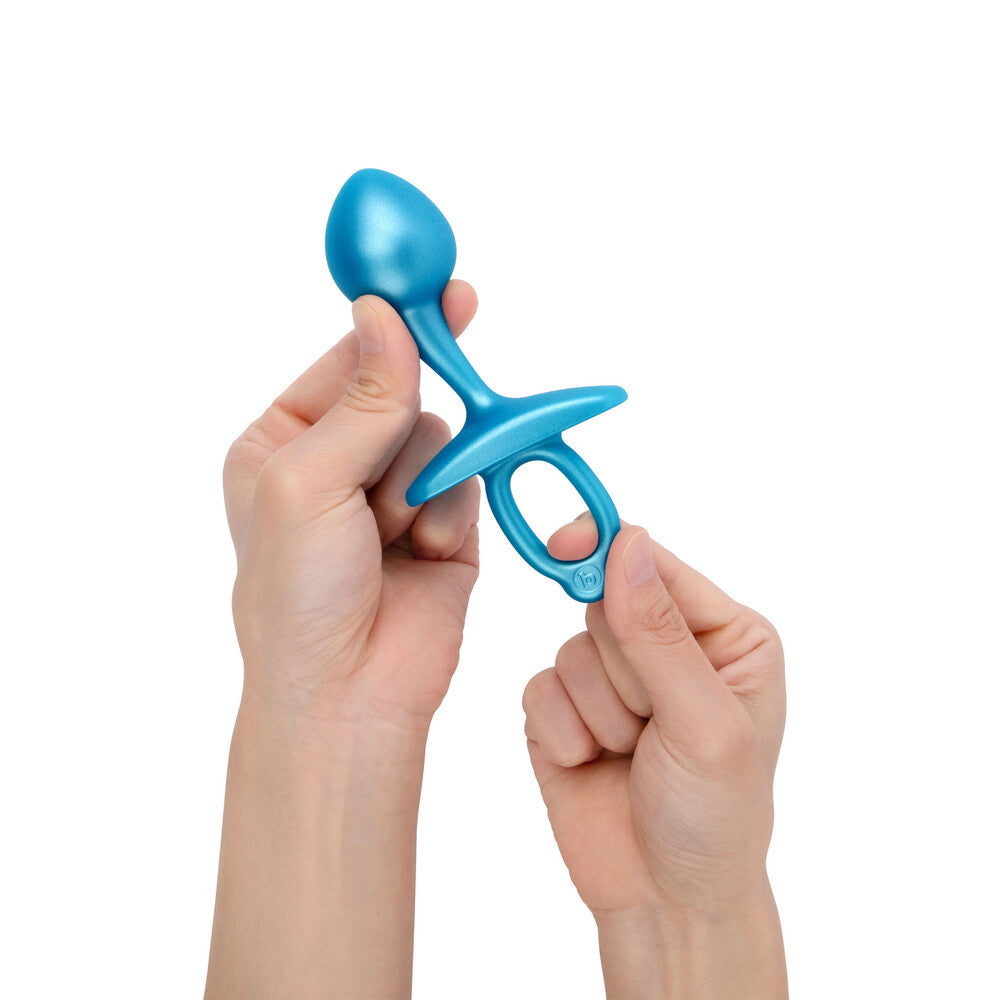 A smooth, purple, bulb-shaped butt plug from B-Vibe, crafted from body-safe silicone.