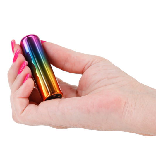 Close-up of a rainbow-coloured, rechargeable mini bullet vibrator by ns novelties, a personal pleasure device.