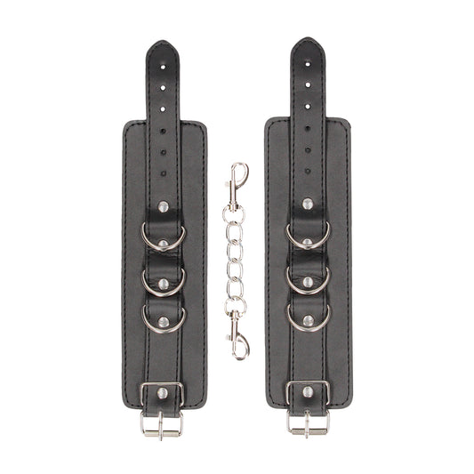 Black leather ouch cuffs from shots toys, a stylish and kinky set of restraints.