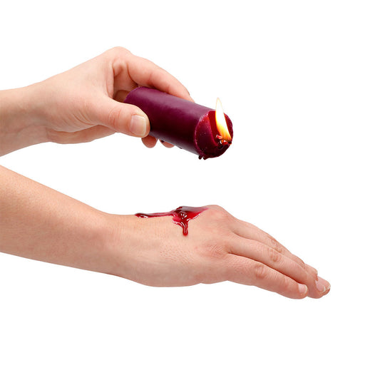 Rose scented wax play candle from shots toys, pink wax in a metal tin.