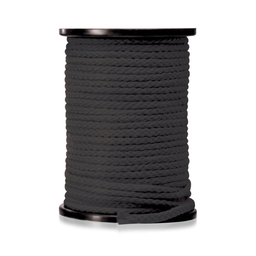 A long length of red bondage rope from the fetish fantasy series, coiled neatly.