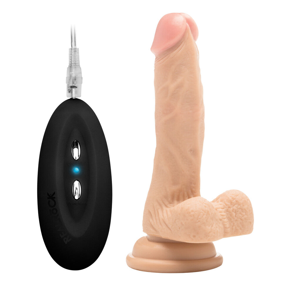 Realistic vibrating cock with scrotum, seven inches long, lifelike texture, skin tone.