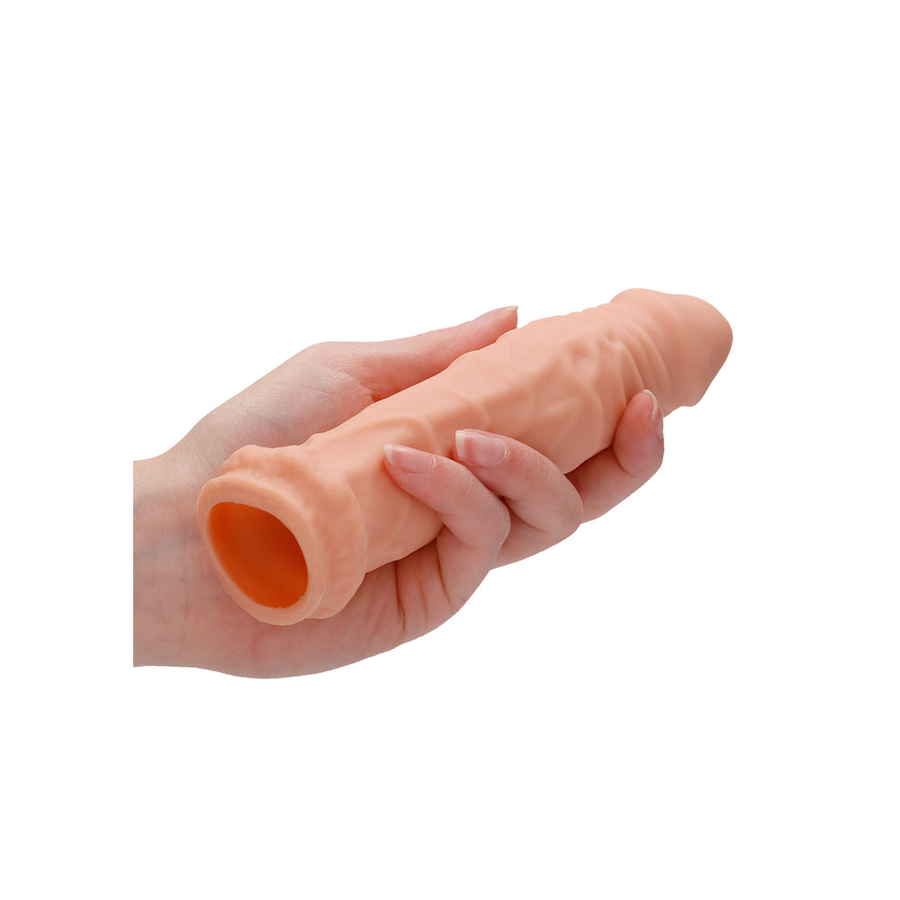 A flesh pink, six-inch penis sleeve from shots toys, designed for pleasure enhancement.