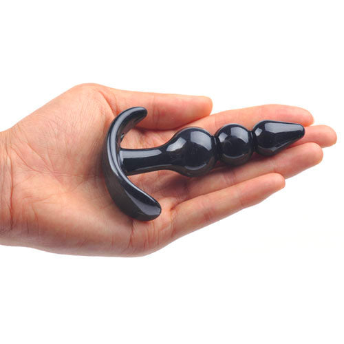 Small black butt plug with beaded design, made by various toy brands.