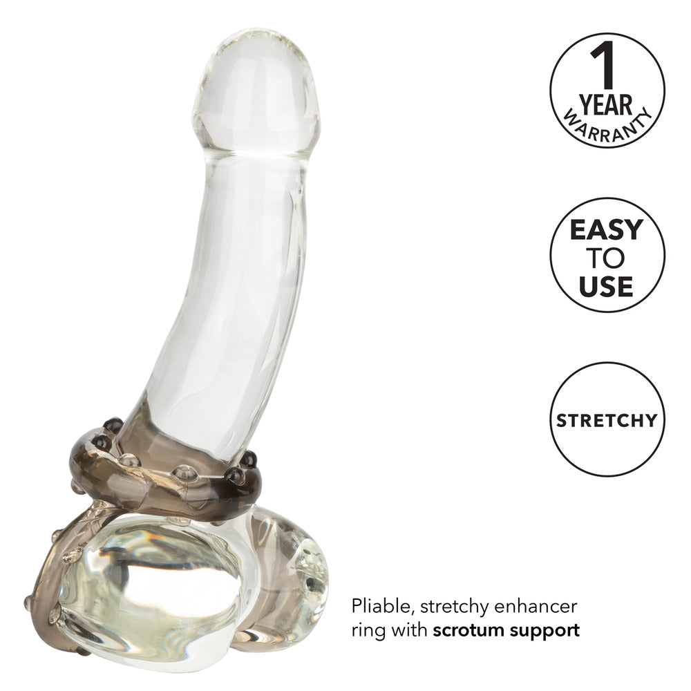 close-up on a silver-tone metal cock ring, possibly a vibrator, for adding pleasure and sensation.