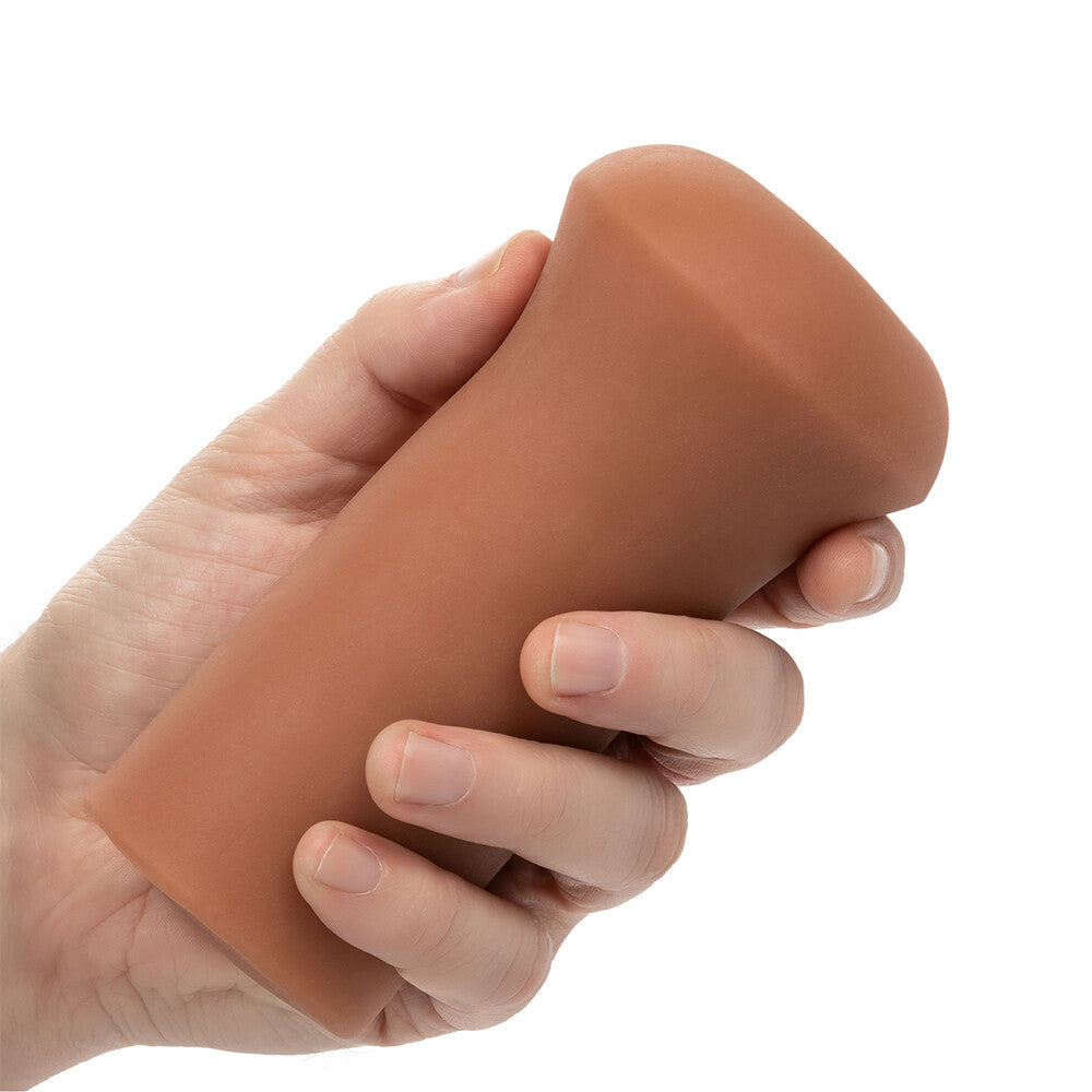 Flesh-brown stroker masturbator from california exotic, textured for enhanced pleasure during solo play.