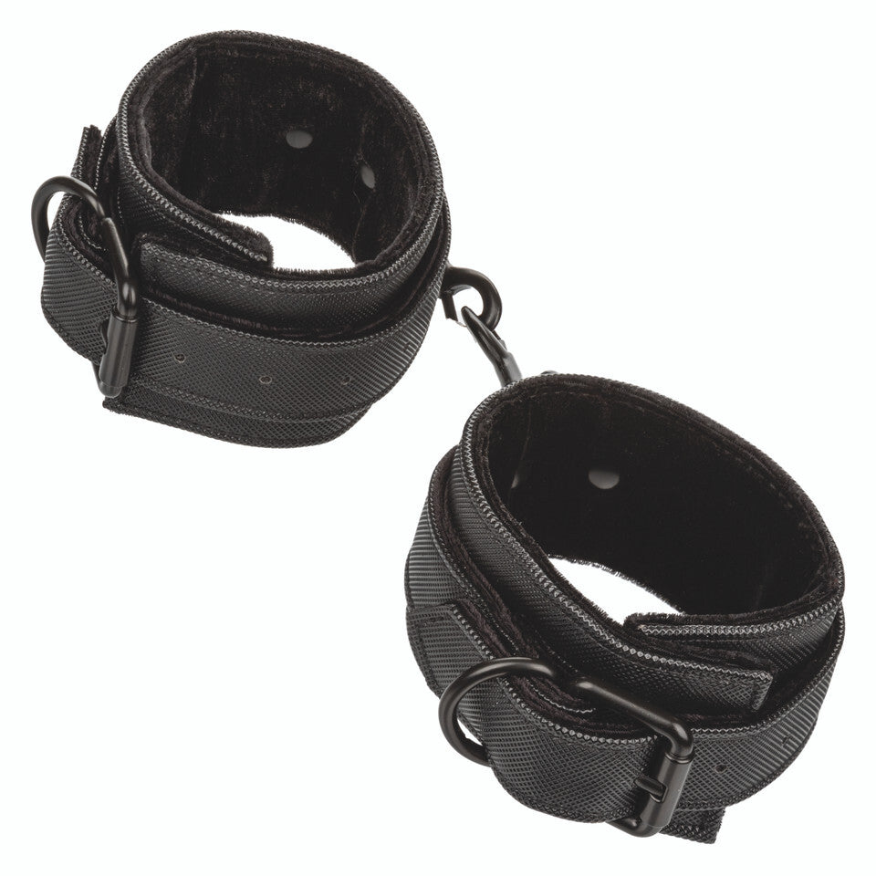 California Exotic Boundless ankle cuffs, black faux leather restraints for playful bondage sessions.