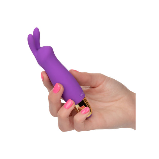 Close-up on a dusky pink, mini rabbit vibrator for clitoral stimulation, smooth finish.