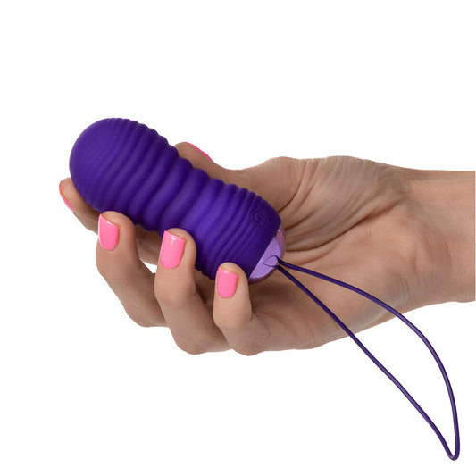 Remote control vibrating bullet egg with ribbed texture, shown in a vibrant purple hue.