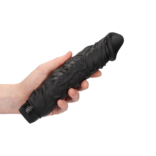 A realistic, black penis vibrator from Shots Toys, showcasing its smooth finish and ergonomic design.