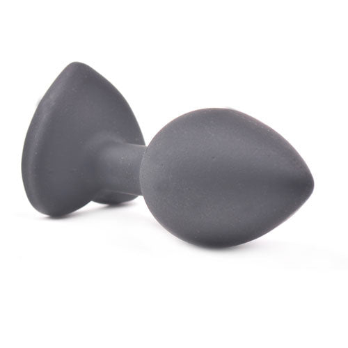 Small, heart-shaped diamond base on a sleek, black butt plug for pleasure.
