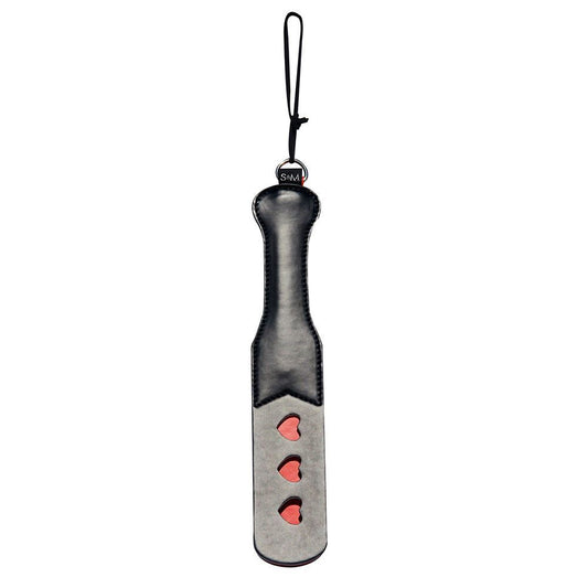 Sportsheets sex and mischief heart paddle, a red faux leather spanking tool with a heart shape.