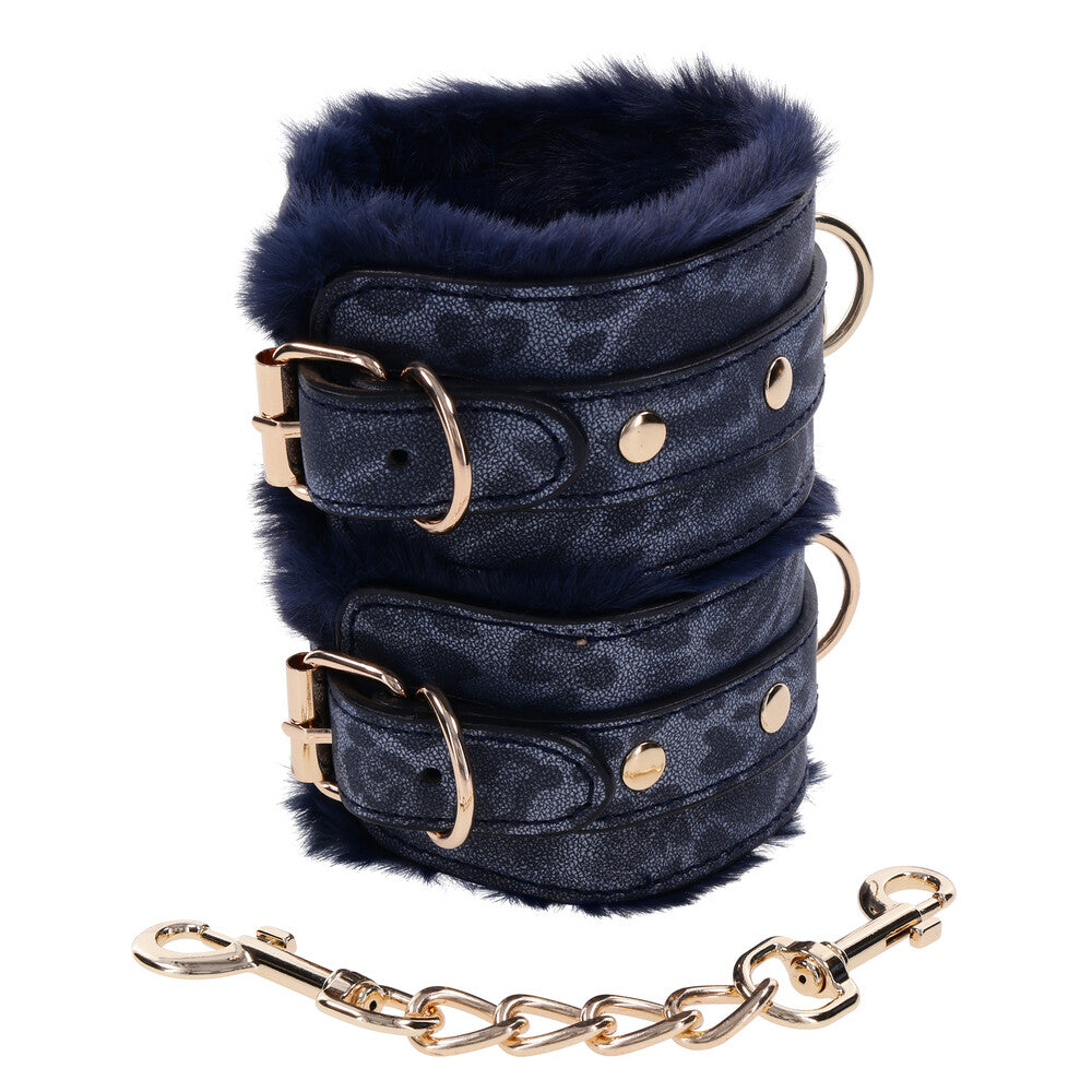 Plush faux fur handcuffs, cougar print, with a soft inner lining for comfortable restraint.