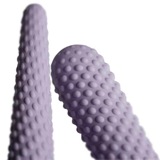 A set of two smooth, gradient purple dilators for kegel exercises and muscle strengthening.