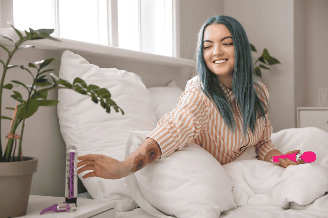 Image of a lady sat in bed, reaching for her sex toy on the nightstand - Adult Store in the UK.