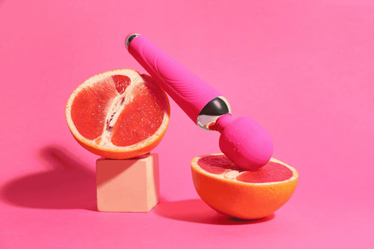 How to use a vibrator - Image of a pink vibrator next to a grapefruit.