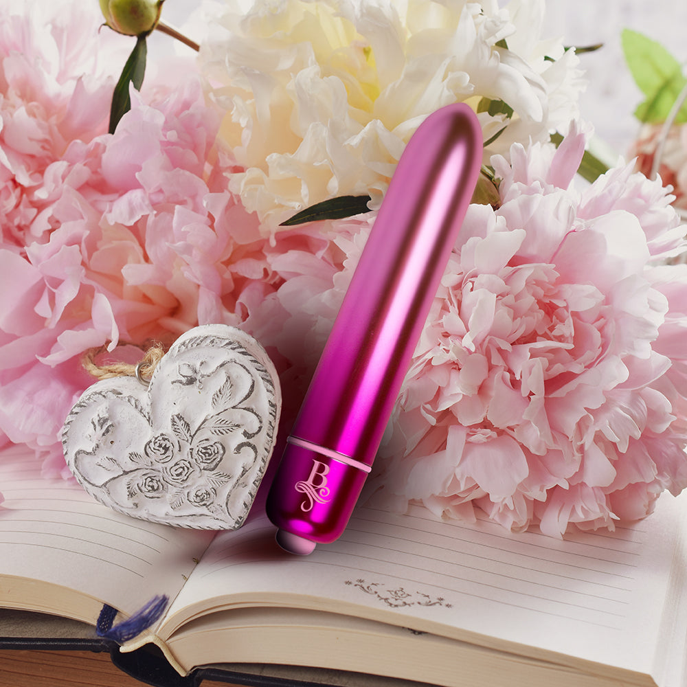 Close-up of a small, sleek, bullet vibrator with a smooth, polished finish, arousing pleasure.