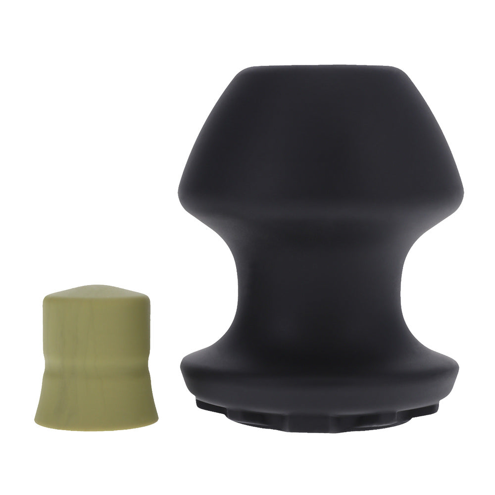 Black, large-sized Doc Johnson Kum Keeper, a tunnel and stretcher style sex toy.