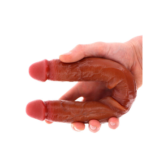 Two realistic silicone dildos joined together, double ended, in a natural skin tone colour.