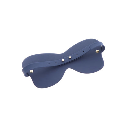 Close-up on a smooth, dark silicone eye mask or blindfold by Taboom, for sleep.