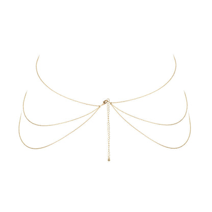 Gold-tone body chain, a stunning piece of body jewellery from bijoux indiscrets, catches the light.