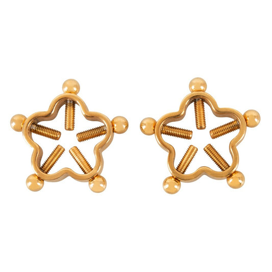 Close-up of golden flower nipple jewellery, a glamorous and daring body adornment.