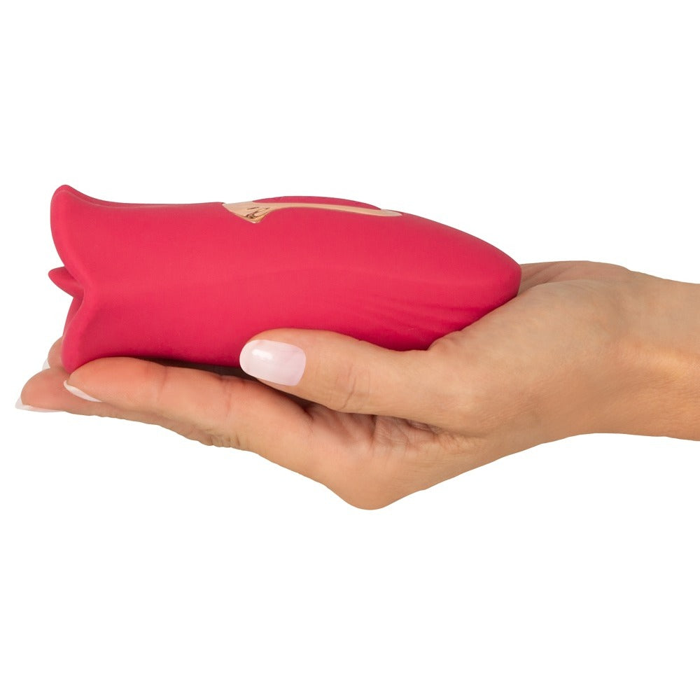 A pink, moving-tongue clitoral vibrator from You2Toys, designed for oral sex simulation.