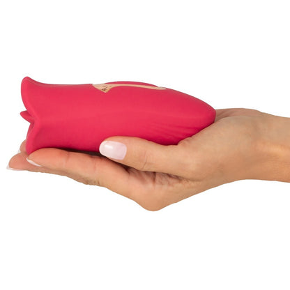 A pink, moving-tongue clitoral vibrator from You2Toys, designed for oral sex simulation.