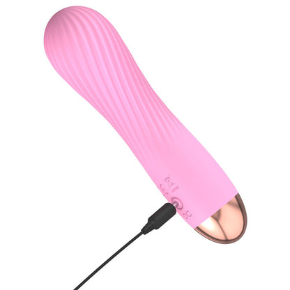 Close-up of a petite, rechargeable vibrator in a smooth, silky pink finish from You2Toys.