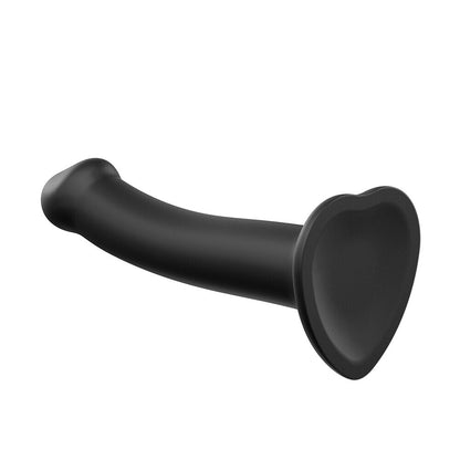 Extra large, black, dual-density silicone strap on dildo; bendable for flexible use.