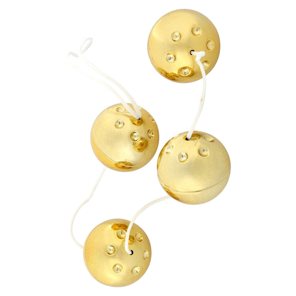 Four gold-coloured vibro orgasm balls from Seven Creations, for enhanced pleasure and pelvic floor exercise.
