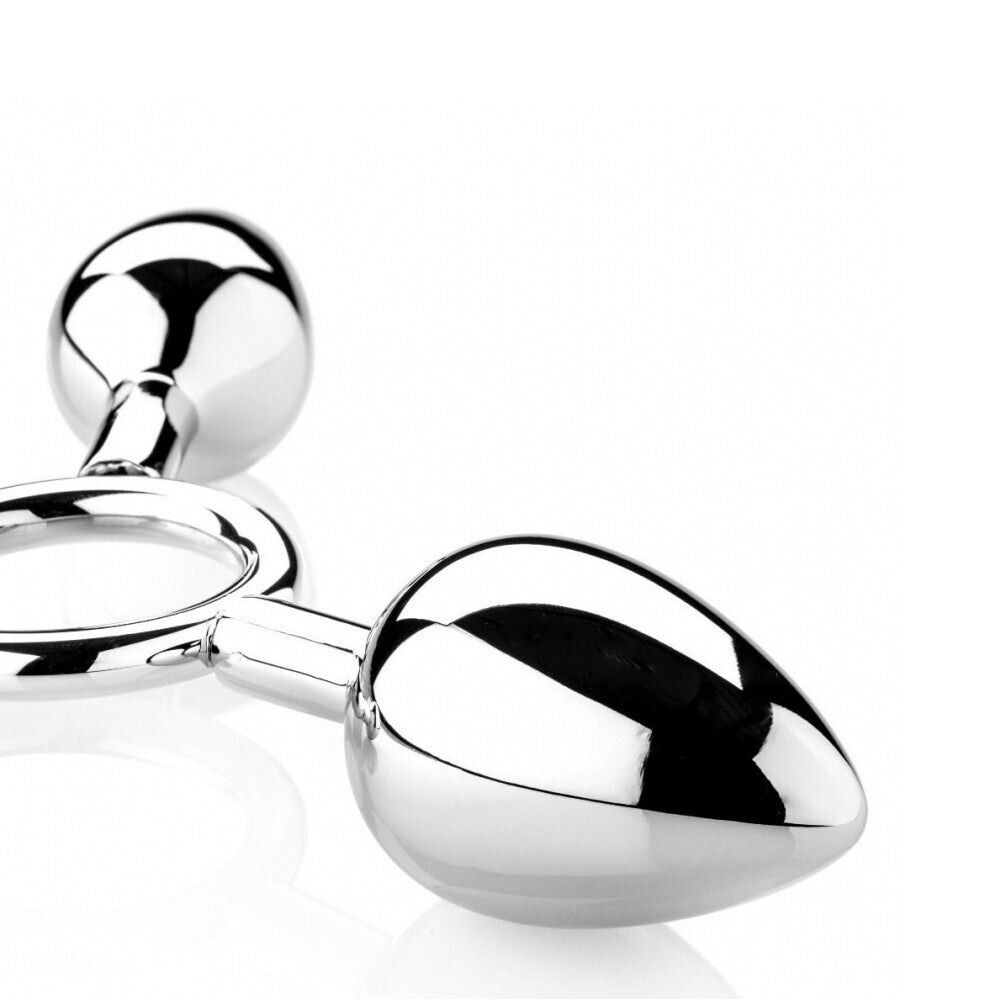 Three metal pig-shaped butt plugs from The Red, in varying sizes, with a polished finish.