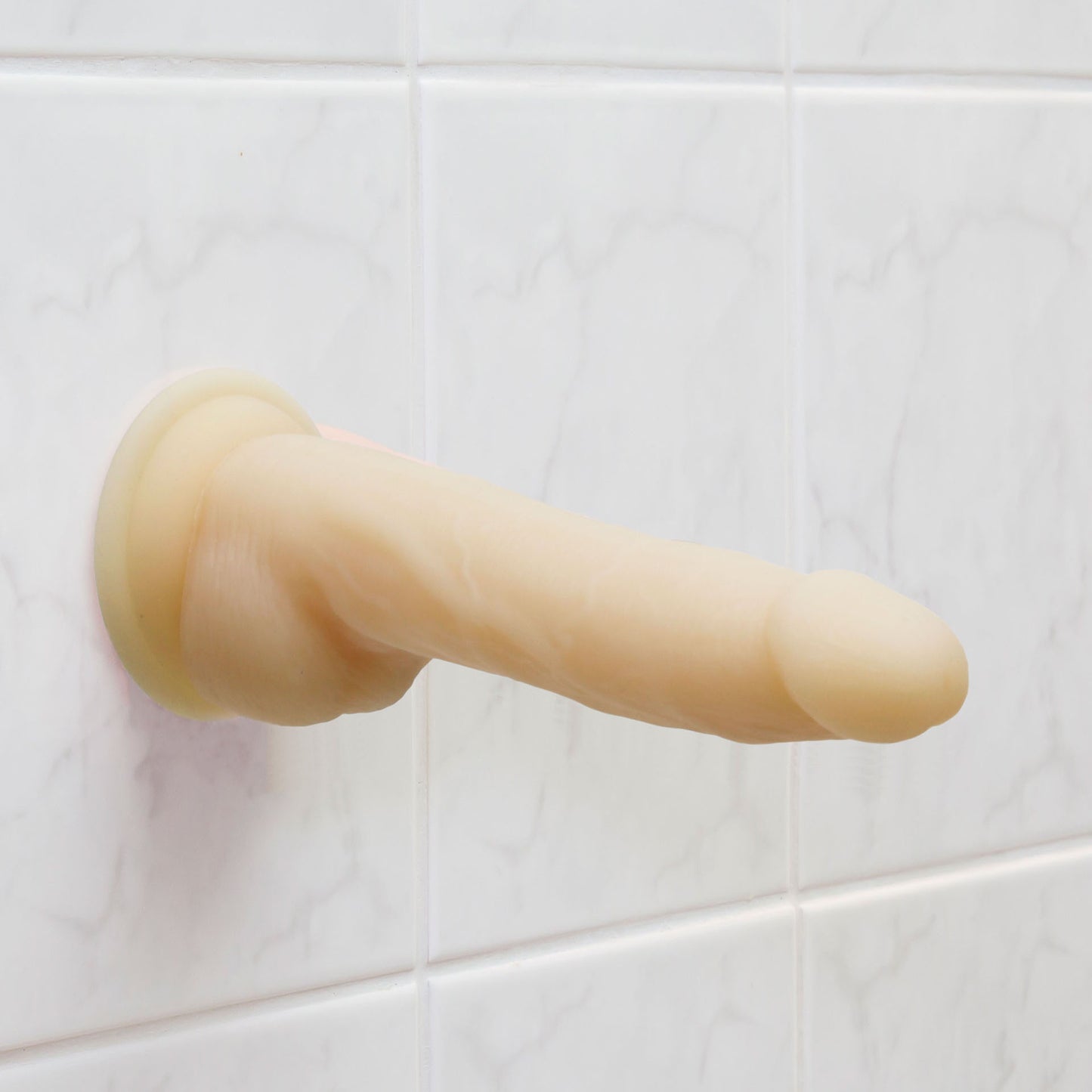 Realistic flesh-toned dildo with a textured shaft, rotating base, and vibrating feature.