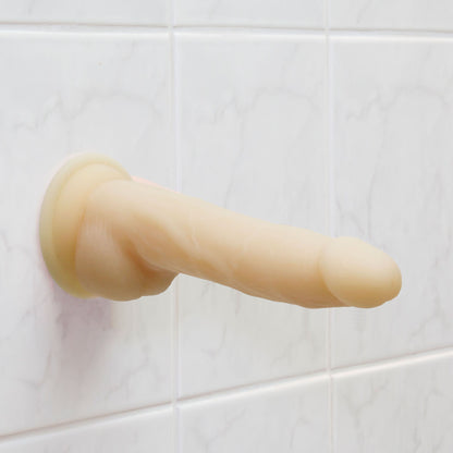 Realistic flesh-toned dildo with a textured shaft, rotating base, and vibrating feature.