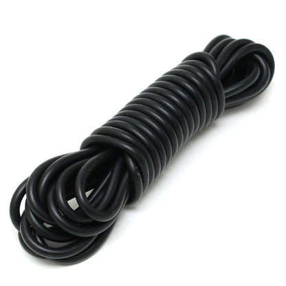 Close-up of flexible, bright pink rimba silicone bondage cord restraint, coiled and ready to use.