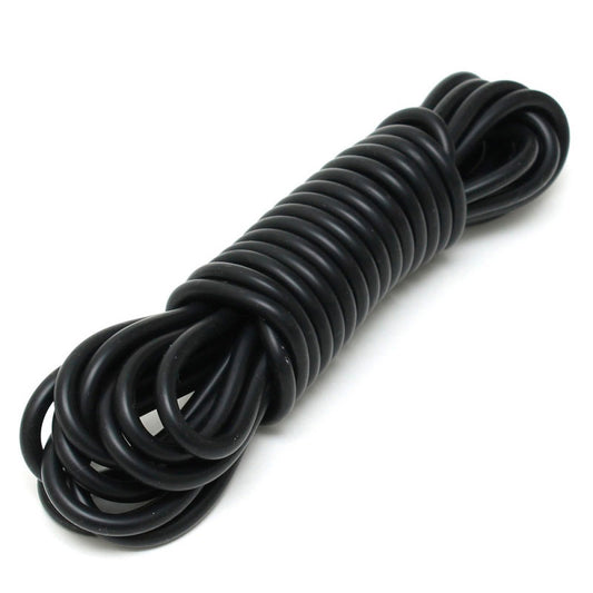 Close-up of flexible, bright pink rimba silicone bondage cord restraint, coiled and ready to use.