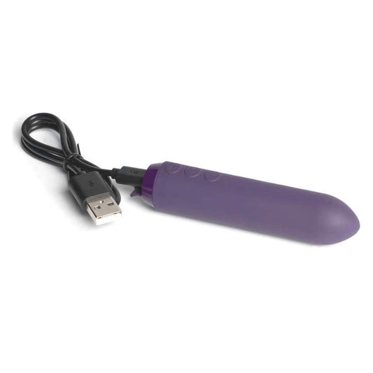 Close-up of a sleek, bullet-shaped vibrator in a vibrant purple colour with a smooth finish.