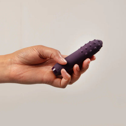 Purple, multi-textured bullet vibrator, a mini vibrator for intimate pleasure and exploration.