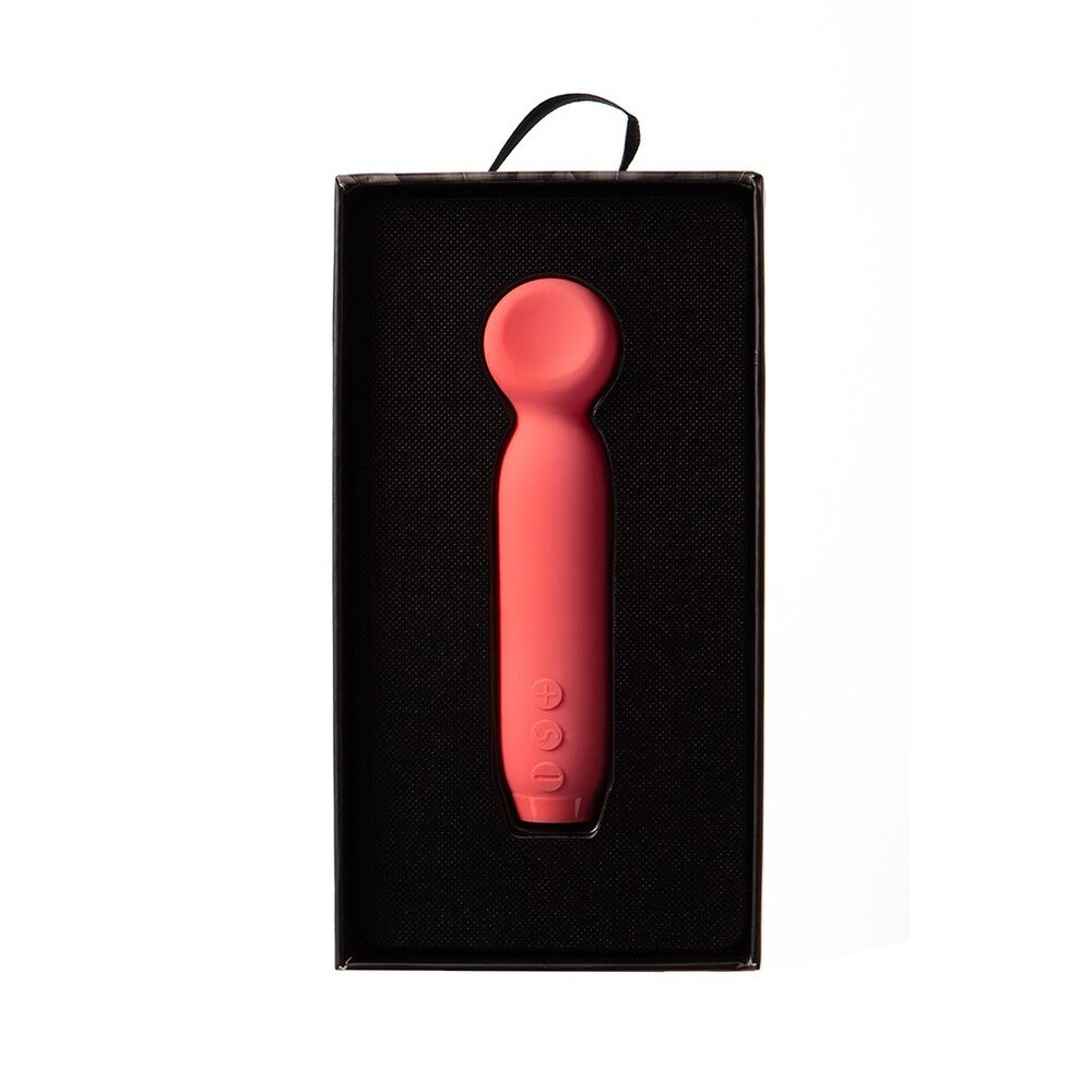 Close-up of a small, sleek, bullet-shaped vibrator in a smooth, tactile material.