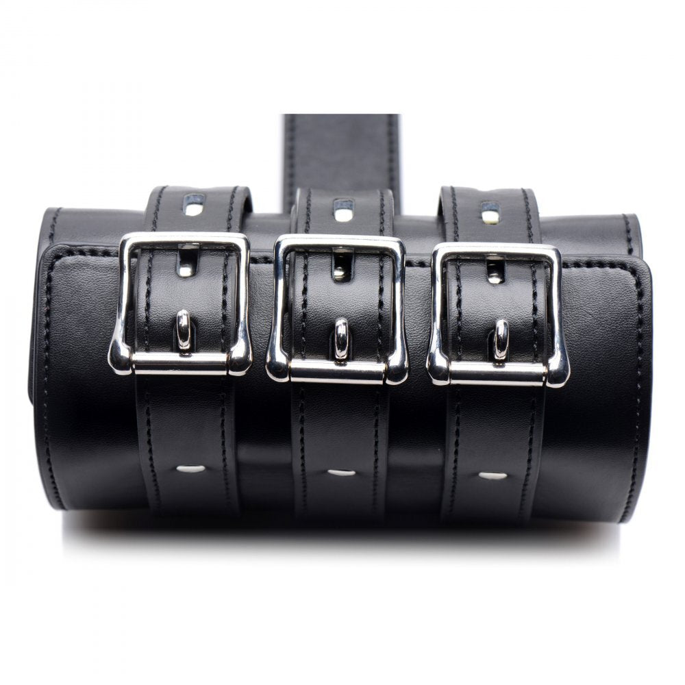 Adjustable black strict arm binder restraint with metal buckles, a key piece of bondage equipment.