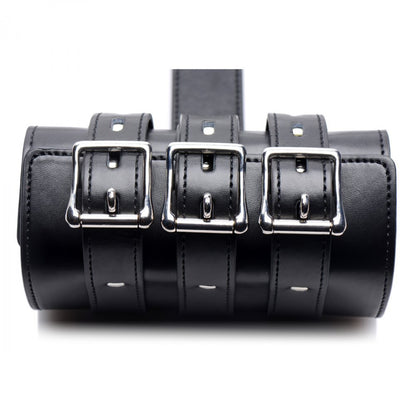 Adjustable black strict arm binder restraint with metal buckles, a key piece of bondage equipment.