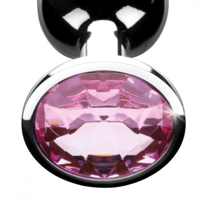 A shiny pink medium-sized butt plug with a multifaceted gem at the base.