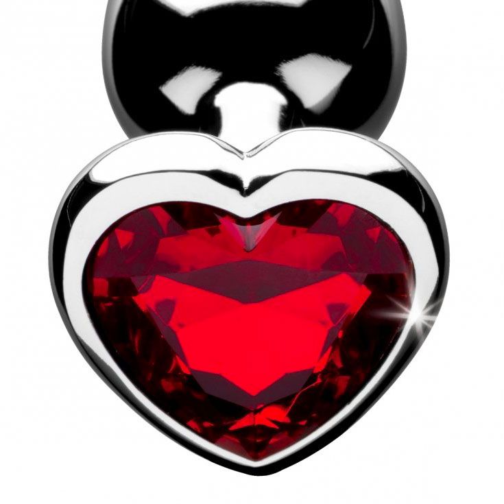 A red, heart-shaped anal plug, medium sized, with a smooth, shiny finish for pleasure.