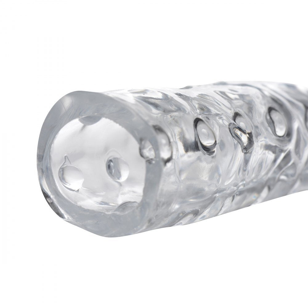 Clear, three-inch penis enhancer sleeve, made of smooth, flexible material for pleasurable use.