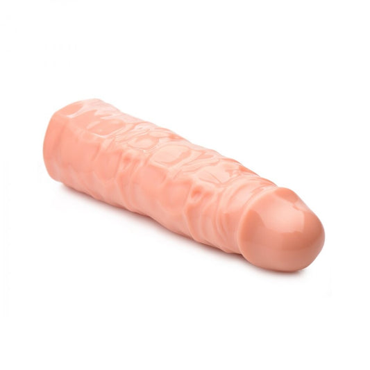 Flesh-toned, three-inch penis enhancer sleeve, designed to increase girth, made from soft material.