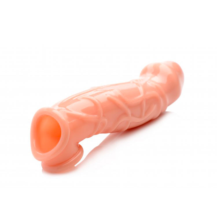 Flesh-coloured, 2-inch penis extender sleeve made from a soft, flexible material for pleasure.